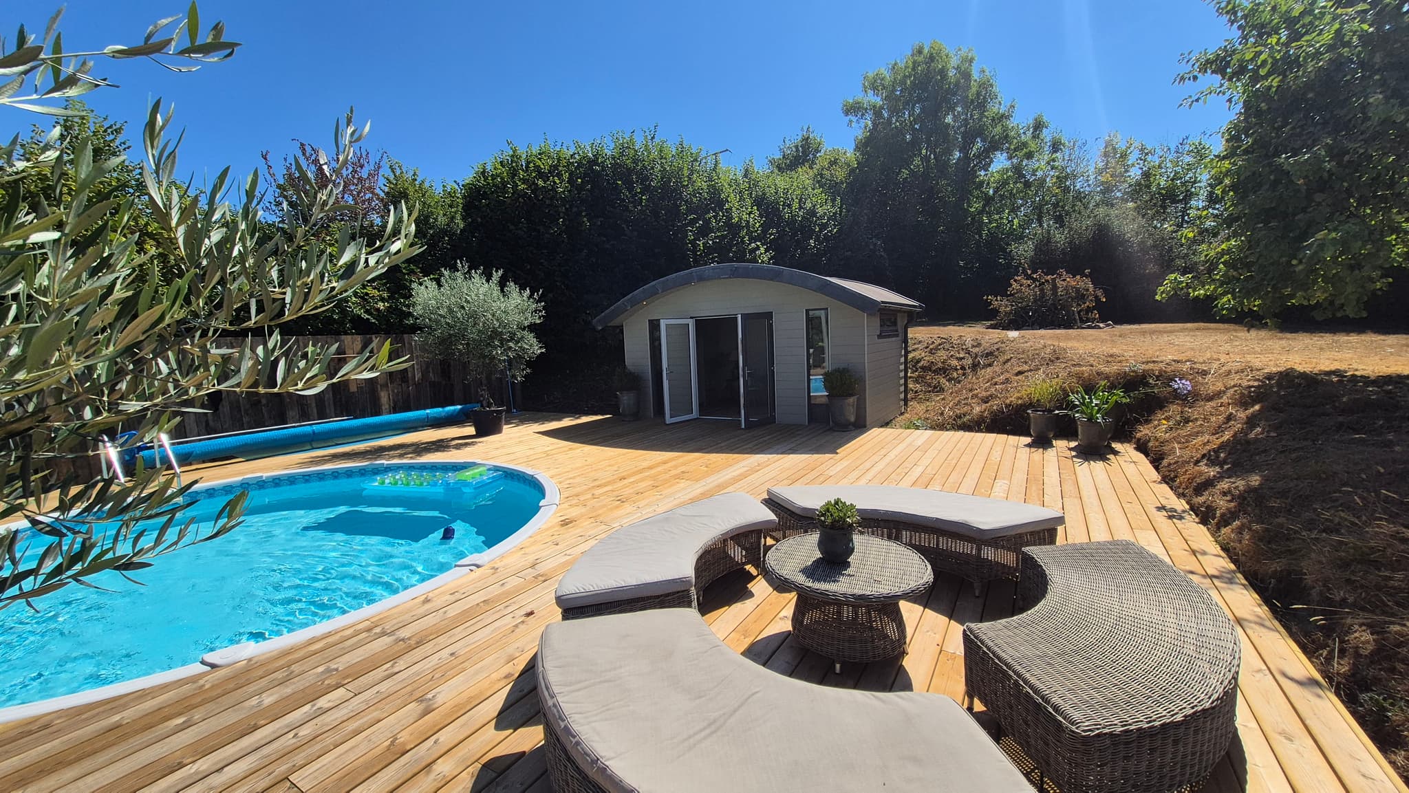 New deck wrapping right around the swimming pool with olive trees