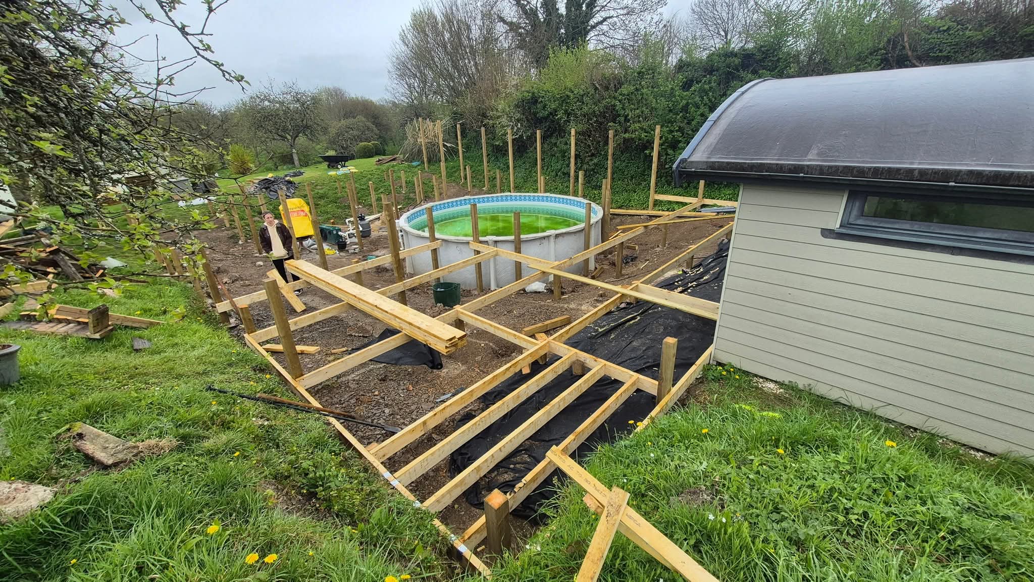 New deck joists being built up around the pool