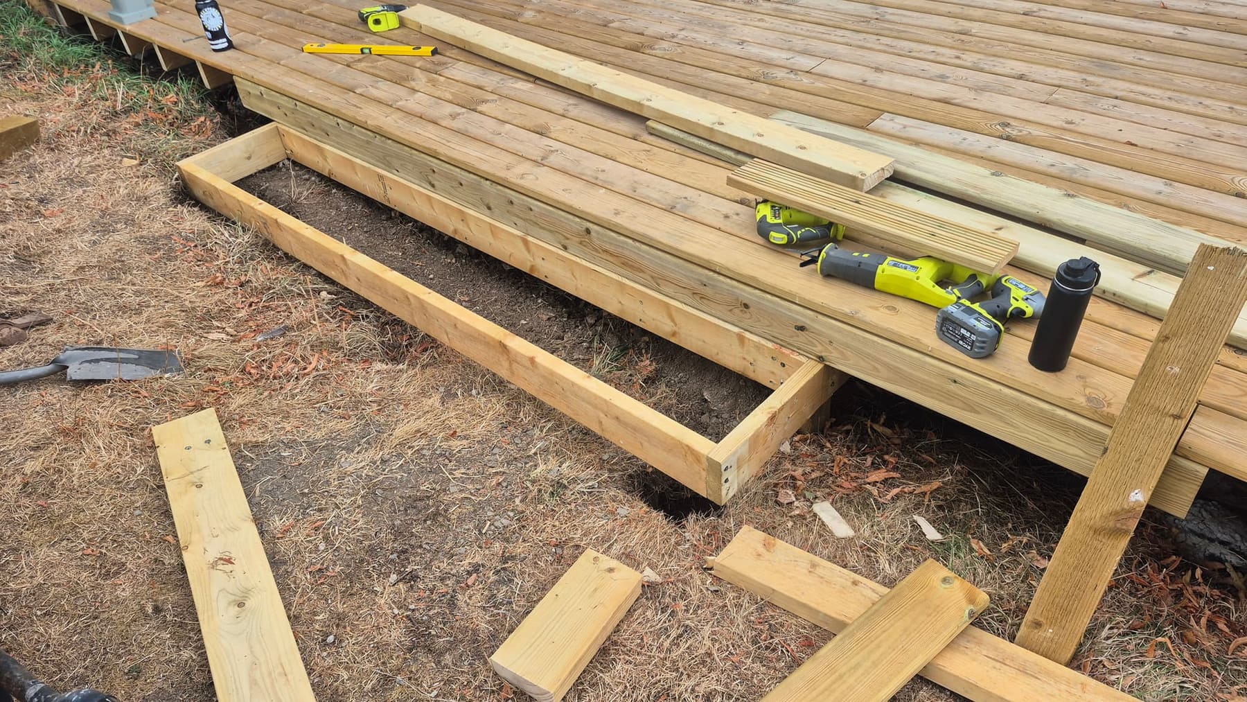New timber step being built along the front edge of the deck