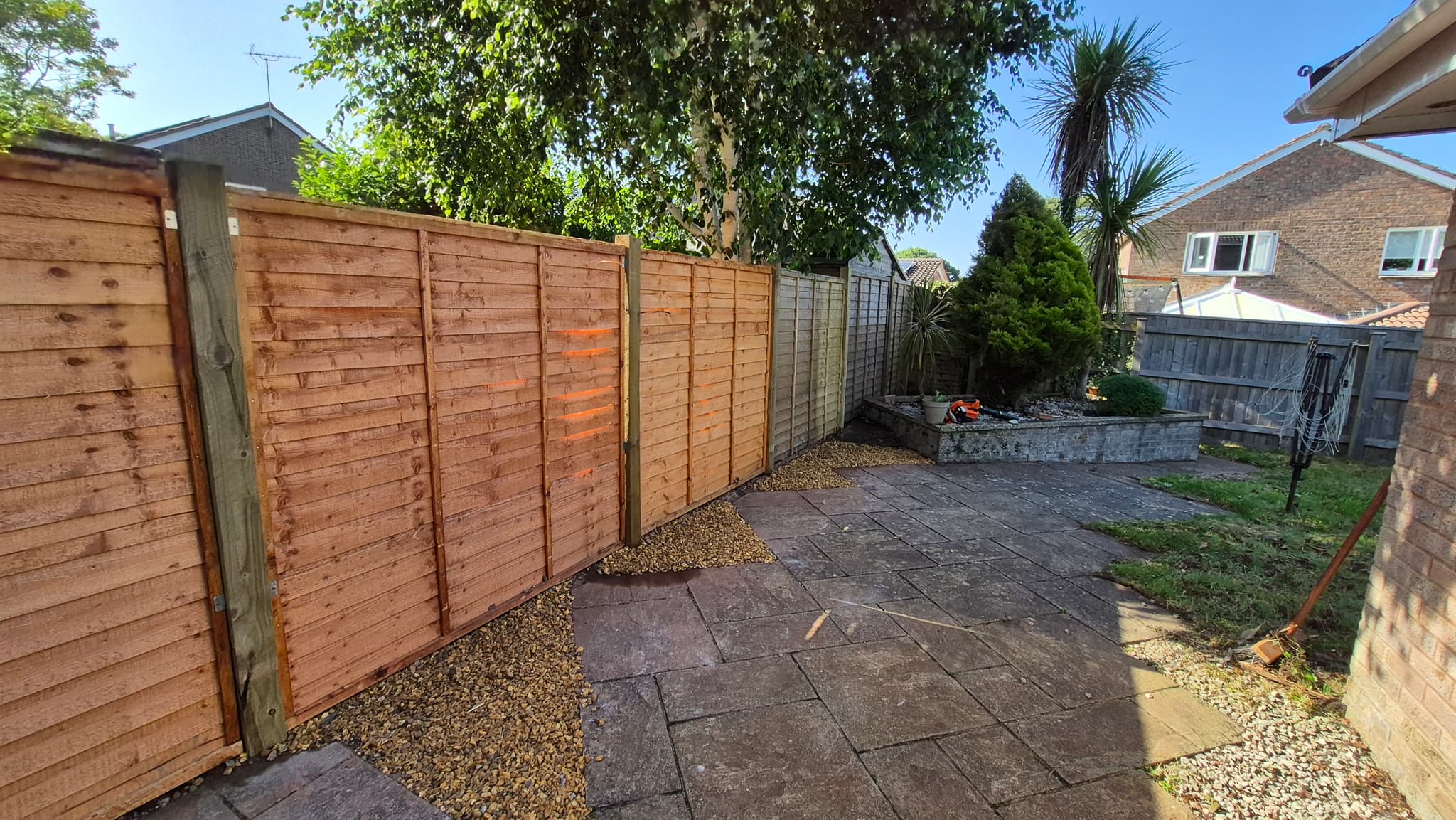 New timber fencing installed around a garden boundary in Devon