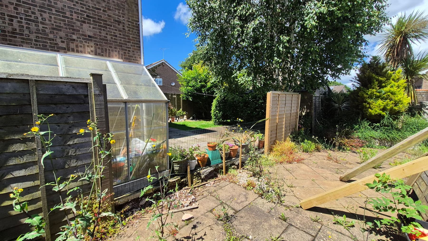 The old fence rotten and propped up before replacement