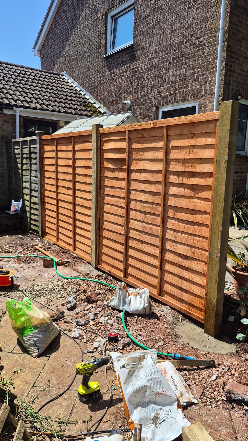 New fence posts and panels being installed