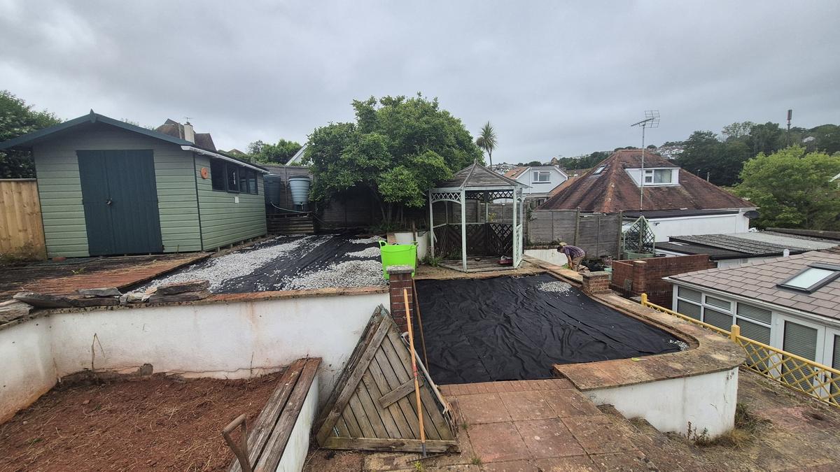 Gravel being spread across the garden levels