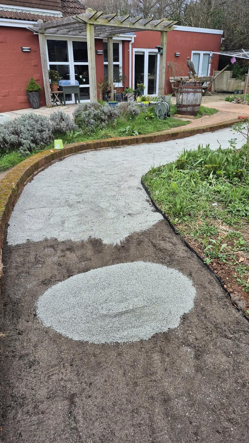Fine gravel being spread on the path surface