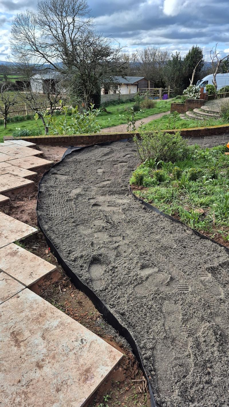 Grit layer being spread on the living path