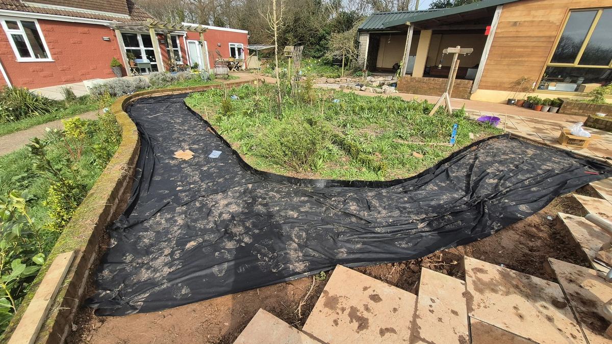 Weed membrane laid along the curved path