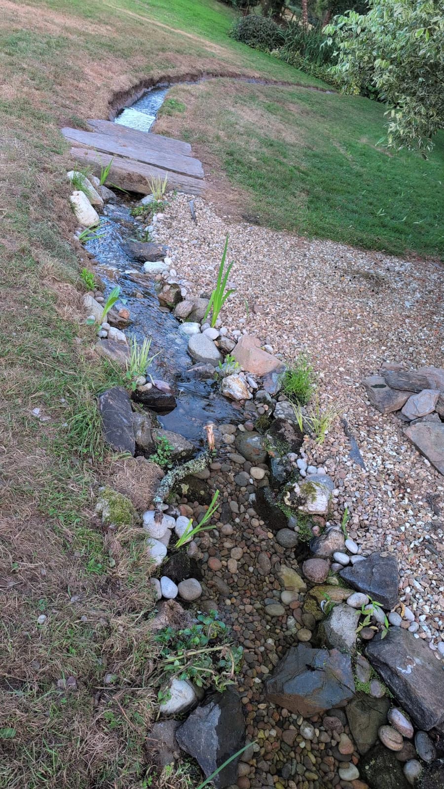 Rebuilt garden rill running into a pond in Devon