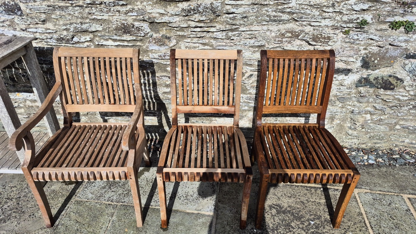 Teak chairs after pressure washing showing natural wood grain