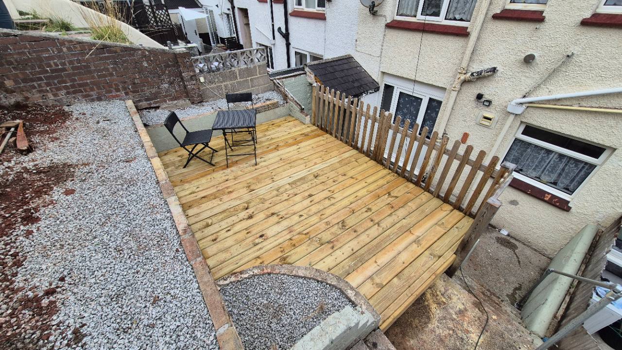 Completed timber deck with seating and boundary fence